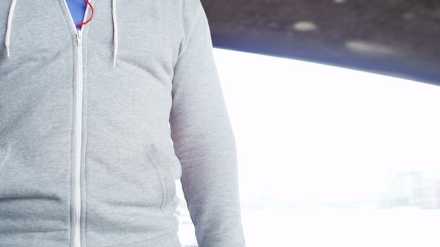  Portrait of athletic black male in a hooded sweatshirt outdoors in the city