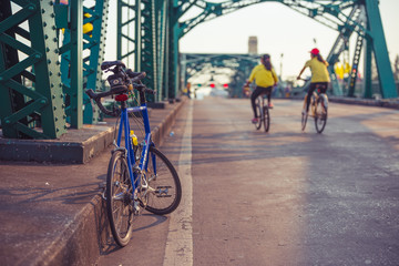 Fototapeta na wymiar Bicycle ride cross the old style bridge.