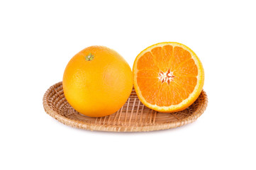 whole and half cut orange in basket on white background