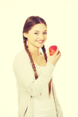 Teenage woman holding an apple.