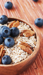 oat meal with walnuts and blueberries selective focus