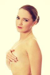 Fototapeta premium Young topless woman covering her breast.