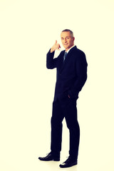 Full length businessman with call me gesture