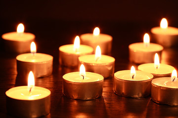 Fototapeta na wymiar Candles On Dark