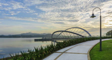 View of pedestrian walkway at Seri Empangan recreational park at Putrajaya during sunrise with...