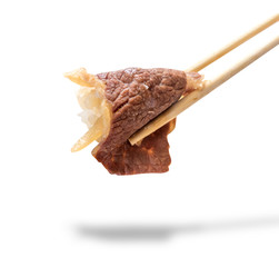 Sliced beef with chopsticks isolated on white with clipping path