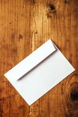 Blank white mailing envelope on office desk