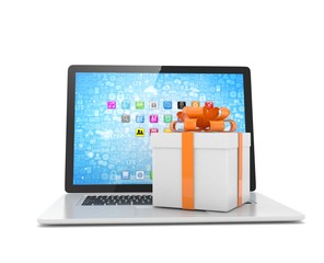 Gift box with ribbon on laptop keyboard