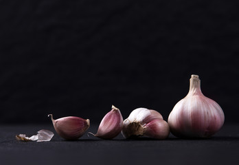  a still life arrangement of Three whole garlic bulbs grouped 