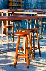 Fototapeta na wymiar Empty street cafe with wooden chairs