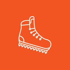 Hiking boot with crampons line icon.