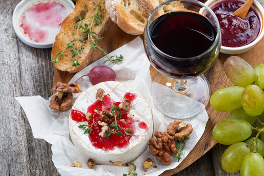 delicious appetizers for wine - camembert, berry jam, toast 