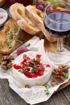 delicious appetizers for wine - camembert, berry jam, toast