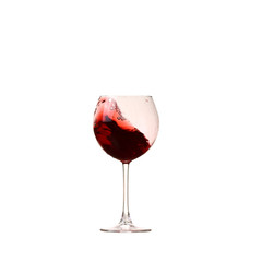 red wine glass on a white background, splash