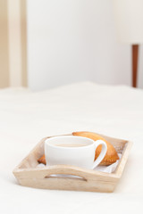 Fototapeta na wymiar cup of coffee with milk and bread on tray