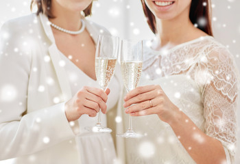 close up of lesbian couple with champagne glasses