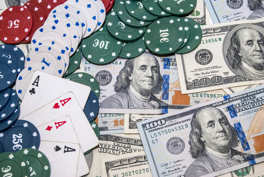 Poker Combination chips, playing cards and usa dollars bills in casino