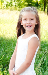 Fototapeta na wymiar Portrait of smiling cute little girl