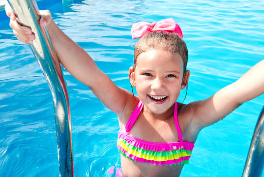 Happy little girl in swimming pool