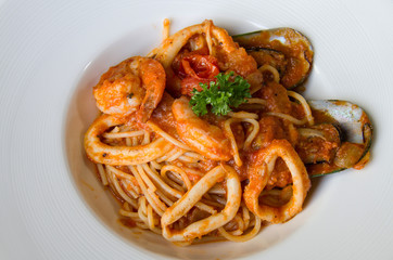spaghetti sea food on white plate.