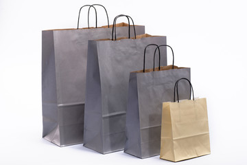 gray and brown paper bags for shopping on a white background