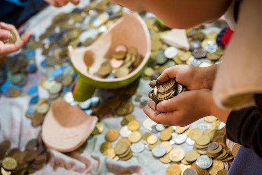 children see the coin treasure of a broken piggy bank