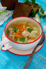 Ear fish soup of red fish salmon on a wooden background