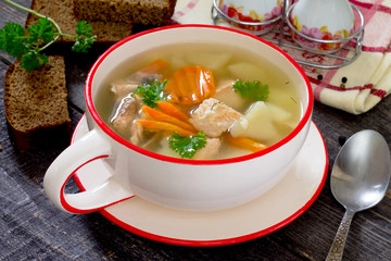 Ear fish soup of red fish salmon in a rustic style