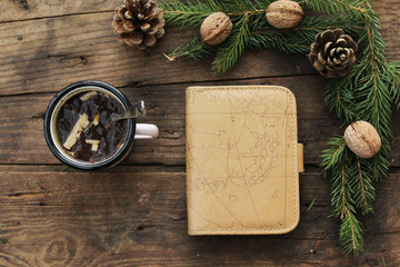 Christmas concept - mug with hot chocolate, walnut, pine cone, note book and fir tree - winter concept