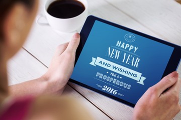 Composite image of woman using tablet pc