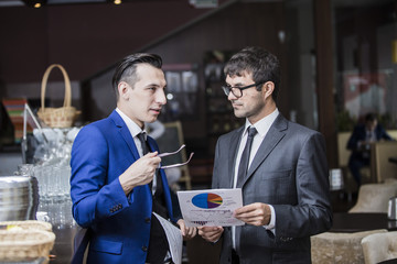 two businessmen communicate happily negotiating in the cafe