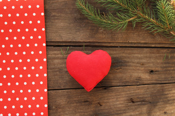 Red heart, fir tree and polka dot texture on wooden table - copy space - love concept