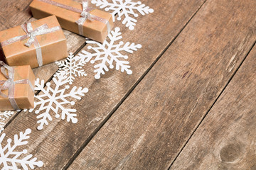 Decorative snowflakes on wooden background