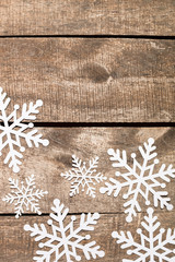 Decorative snowflakes on wooden background