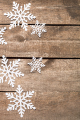 Decorative snowflakes on wooden background