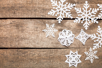 Decorative snowflakes on wooden background