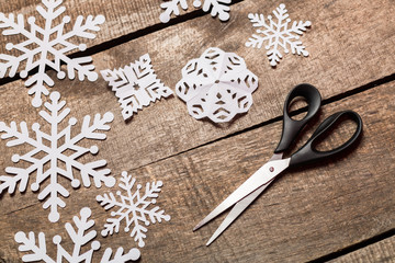 Decorative snowflakes on wooden background