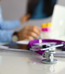 Medical doctor  sitting at table and looking patients roentgen