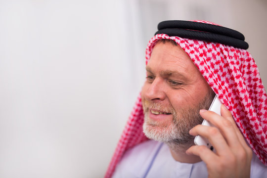 Arabian business man in his home office using smart phone