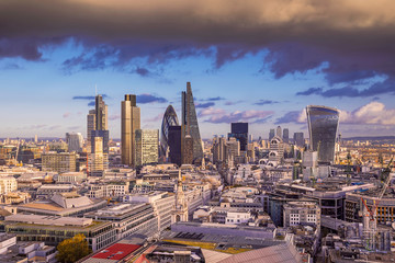 Naklejka na ściany i meble Dark clouds over London's business district at sunset - Panoramic skyline of London - UK