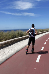 guy skating in-line near the sea, in Portugal