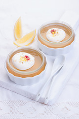 Lemon jelly with cream and jam in a glass on a white board.