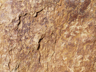 Dark brown stone with cracks on the surface