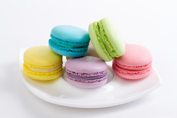Collection of brightly colored French macarons on white backgrou