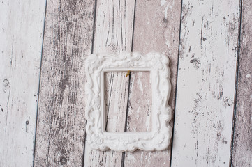 White photo frame on wooden wall