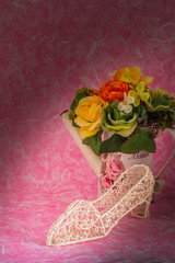 Shoes and a vase on  background.