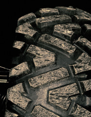 Tire on off-road car closeup, abstract background for transport concept.