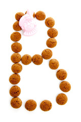 Ginger nuts, pepernoten, in the shape of letter B isolated on wh