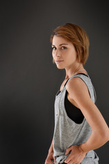 Cheerful fitness girl on grey background, isolated