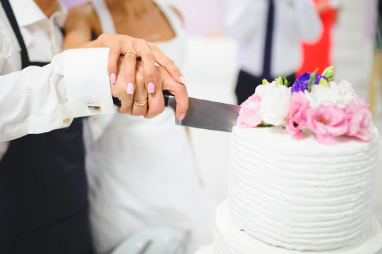 Newlyweds Cutting Cake